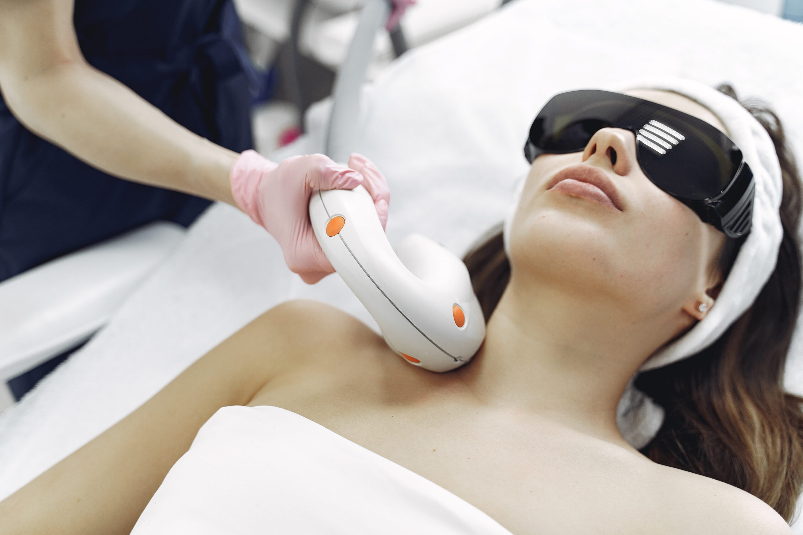 Cosmetologist use laser. Woman with cosmetologist. Lady in a beauty studio.